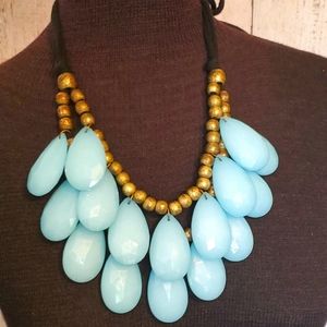 Bold blue teardrop dangle necklace on black velvet